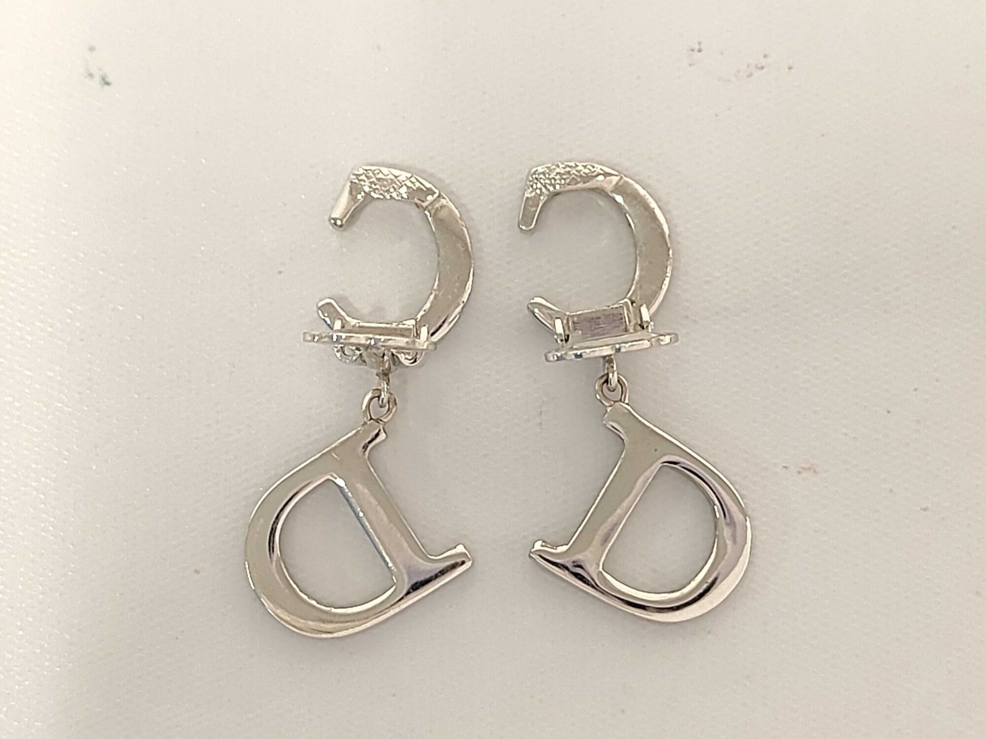 Back view of Christian Dior earrings showing open paddle clip backings and smooth metal reverse.