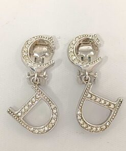 Front view of Christian Dior CD logo drop clip-on earrings in silver-tone metal with clear accents.