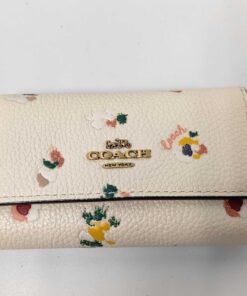 Front view of Coach chalk pebble leather floral 6-ring key case with gold-tone logo.