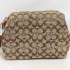 Front view of Coach signature canvas cosmetic pouch in khaki and brown