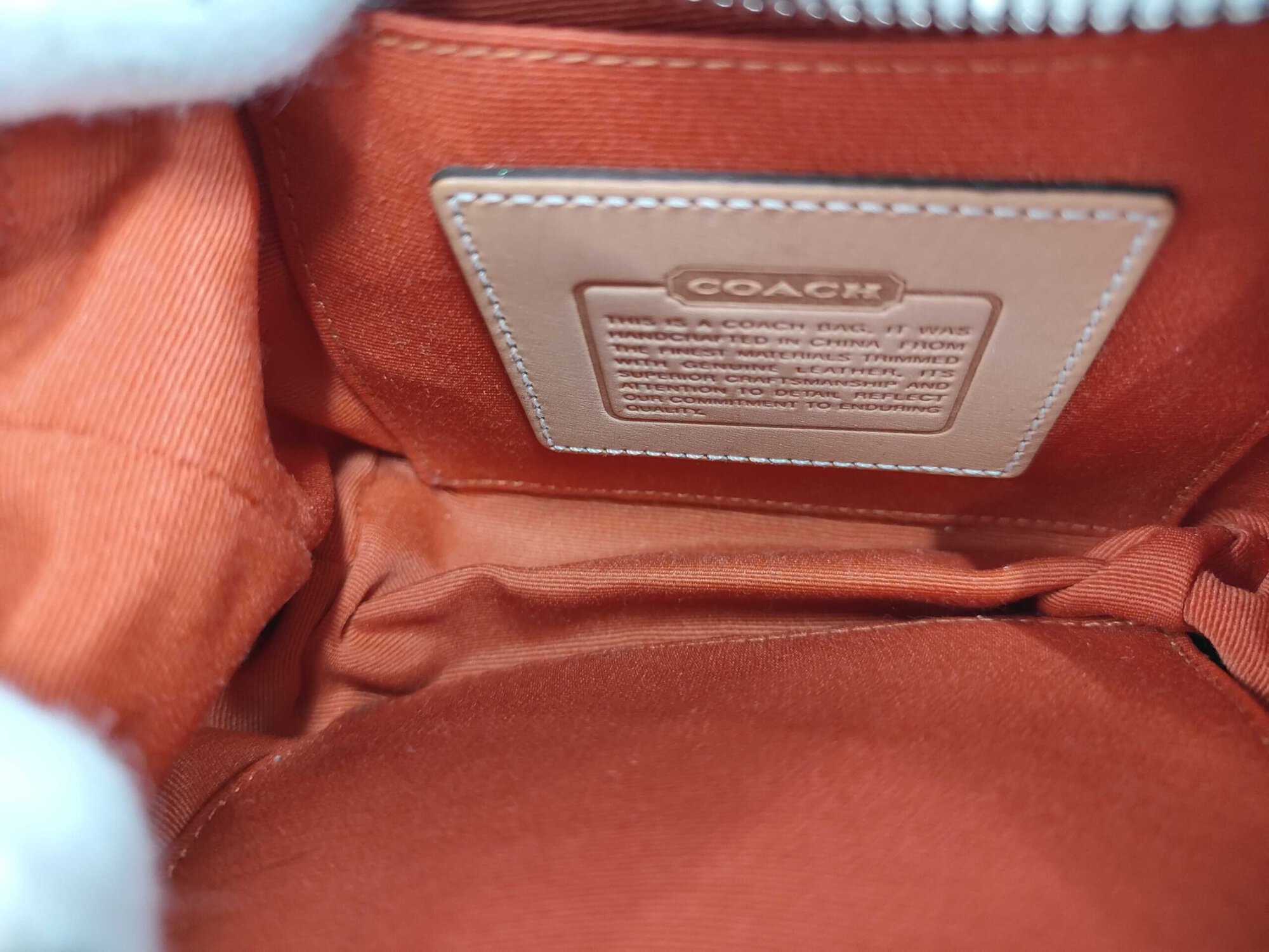 Interior compartment showing orange lining and slip pocket