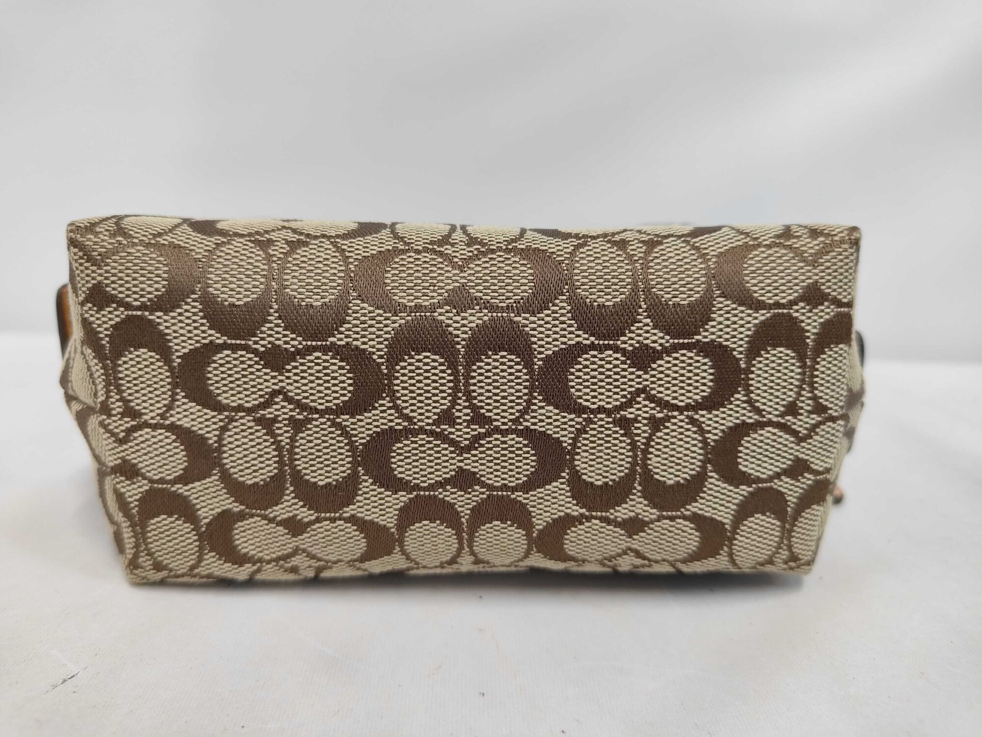 Bottom panel of Coach signature canvas cosmetic pouch