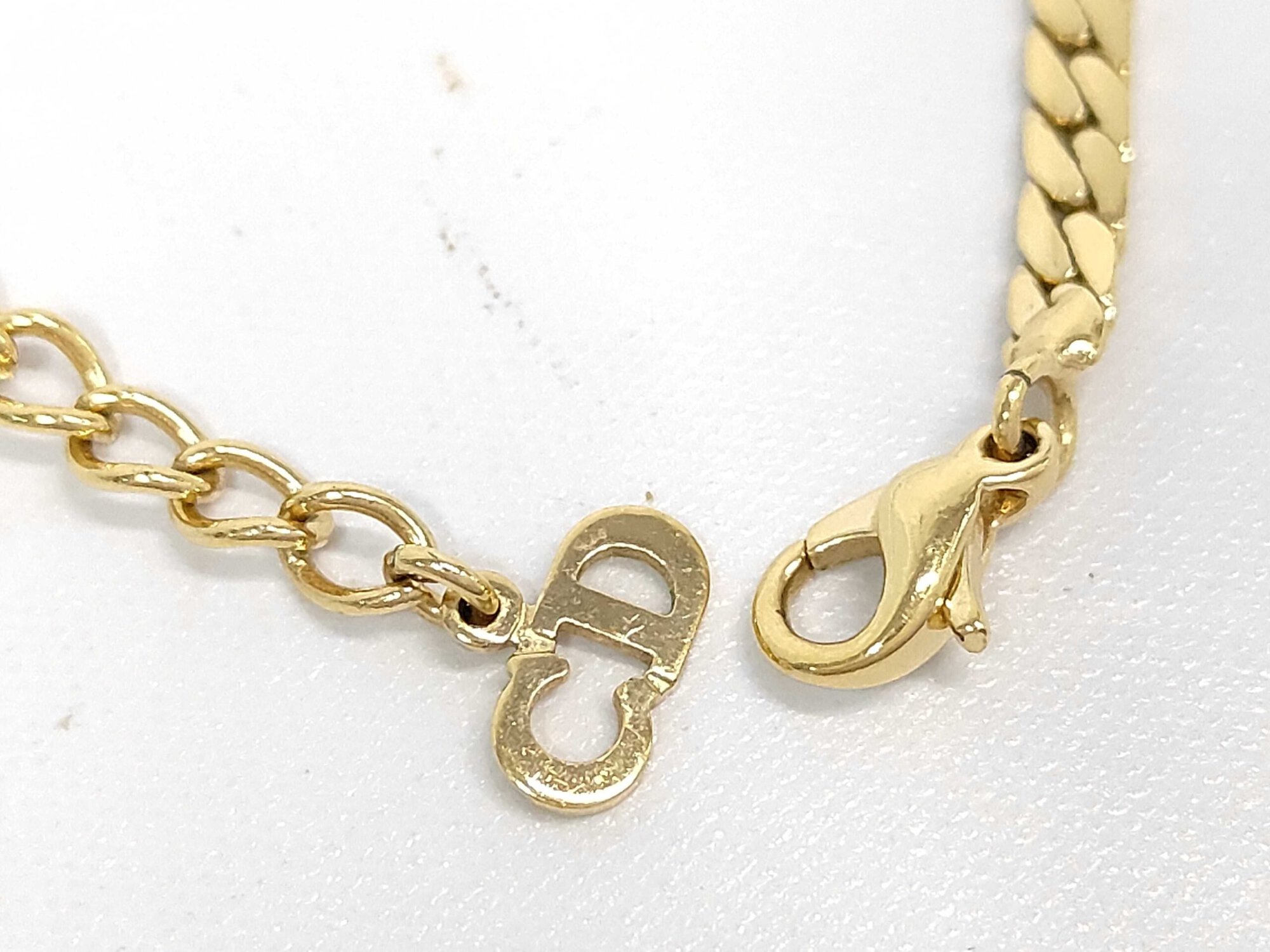 Lobster claw clasp and interlocking CD logo charm on extender chain.