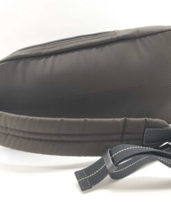Profile view of Coach sling pack showing padded shoulder strap and side zipper closure.