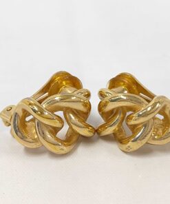 Front view of Christian Dior gold-tone twist knot clip-on earrings on a white surface.