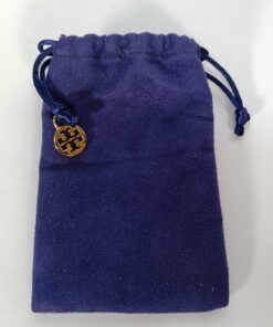 Purple fabric drawstring storage pouch with gold-tone Tory Burch logo charm