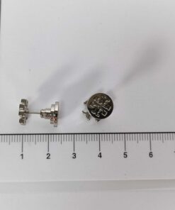 Tory Burch silver-tone stud earrings aligned against a centimeter ruler