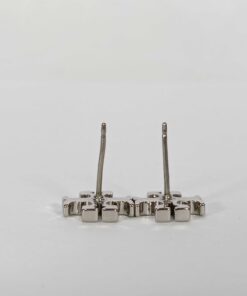 Rear view of Tory Burch stud earrings showing post stems with one bent post