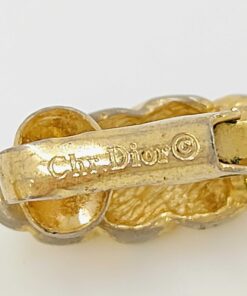 Macro close-up of stamped Chr. Dior copyright hallmark on earring paddle clip.