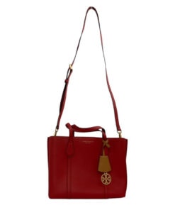 Front view of Tory Burch red pebbled leather tote bag with hanging tan clochette and shoulder strap