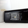 Front view of Vivienne Westwood black patent bow continental wallet with silver box