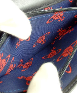 Close-up of red printed Orb textile lining and gold-tone zipper pull
