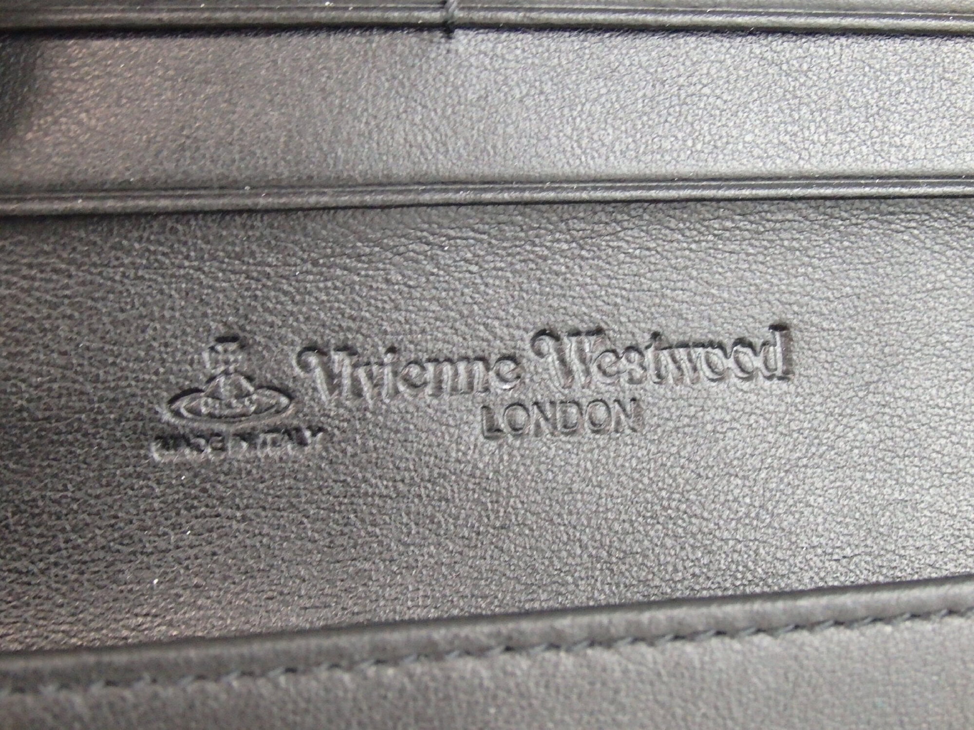Close-up of debossed Vivienne Westwood London Made in Italy leather stamp