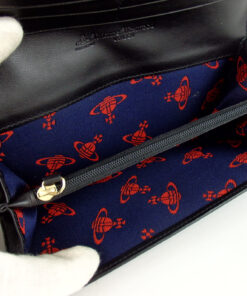 Expanded interior compartment view showing red Orb patterned lining and zip pocket