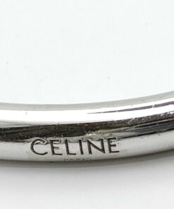 Engraved Celine Paris maker signature along terminal edge of cuff bracelet