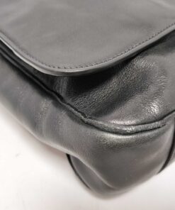 Close-up of bottom corner piping showing minor rubbing and wear.