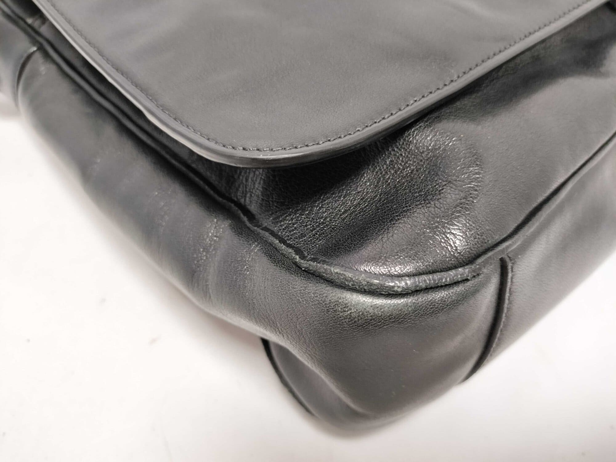 Close-up of bottom corner piping showing minor rubbing and wear.