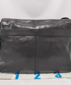 Rear view of Coach Bleecker messenger bag with tape measure showing width.