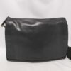 Front view of Coach Bleecker black leather courier messenger bag with flap closure.