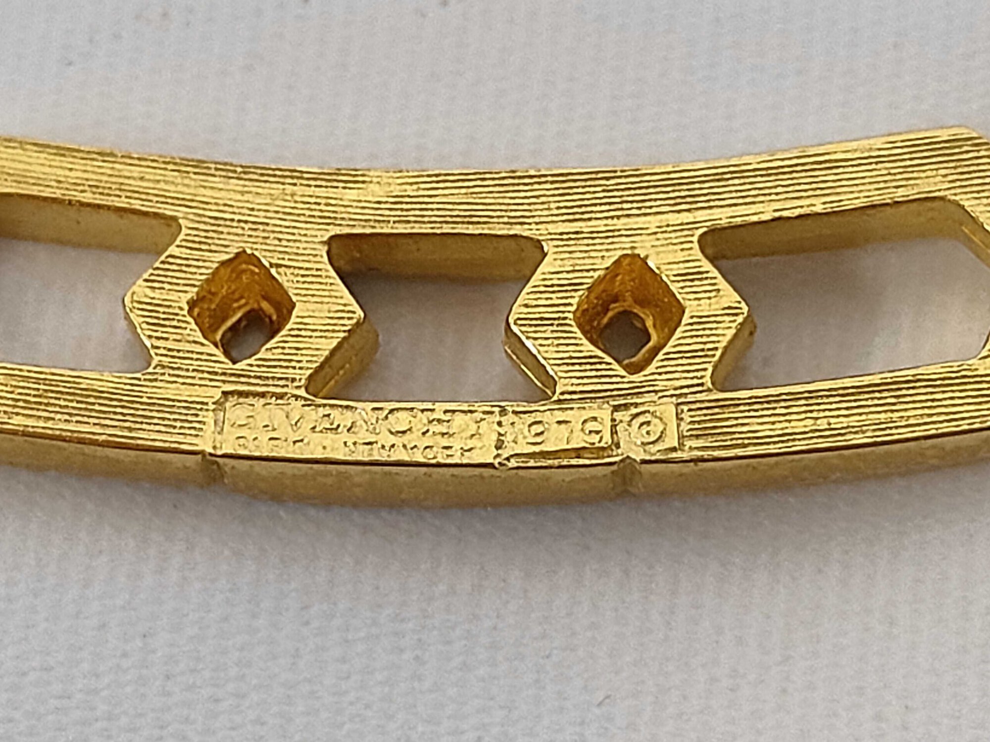 Close-up of hallmark on reverse reading Givenchy Paris New York 1979 with copyright symbol.