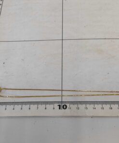 Givenchy necklace laid folded alongside measuring grid
