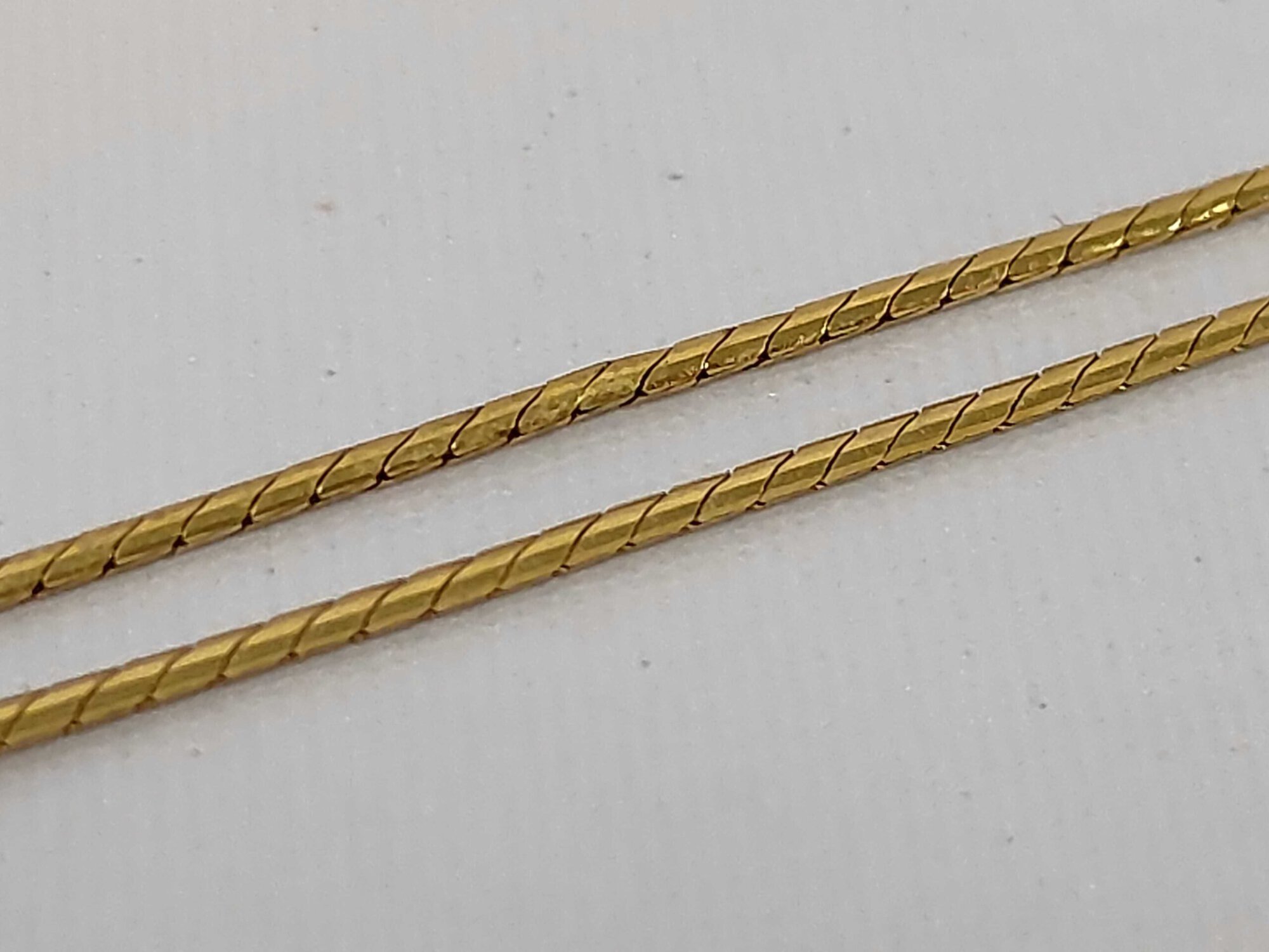Detail view of gold-tone necklace chain links