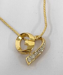 Givenchy gold-tone asymmetrical heart pendant necklace with G monogram and clear accents