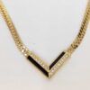 Christian Dior gold-tone chevron station necklace with black accents and clear stones.