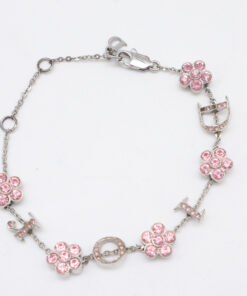 Christian Dior silver-tone charm bracelet arranged in an oval featuring pink floral stations and D-I-O-R letter charms.