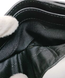 Interior view of full-length horizontal billfold section with black jacquard textile lining.