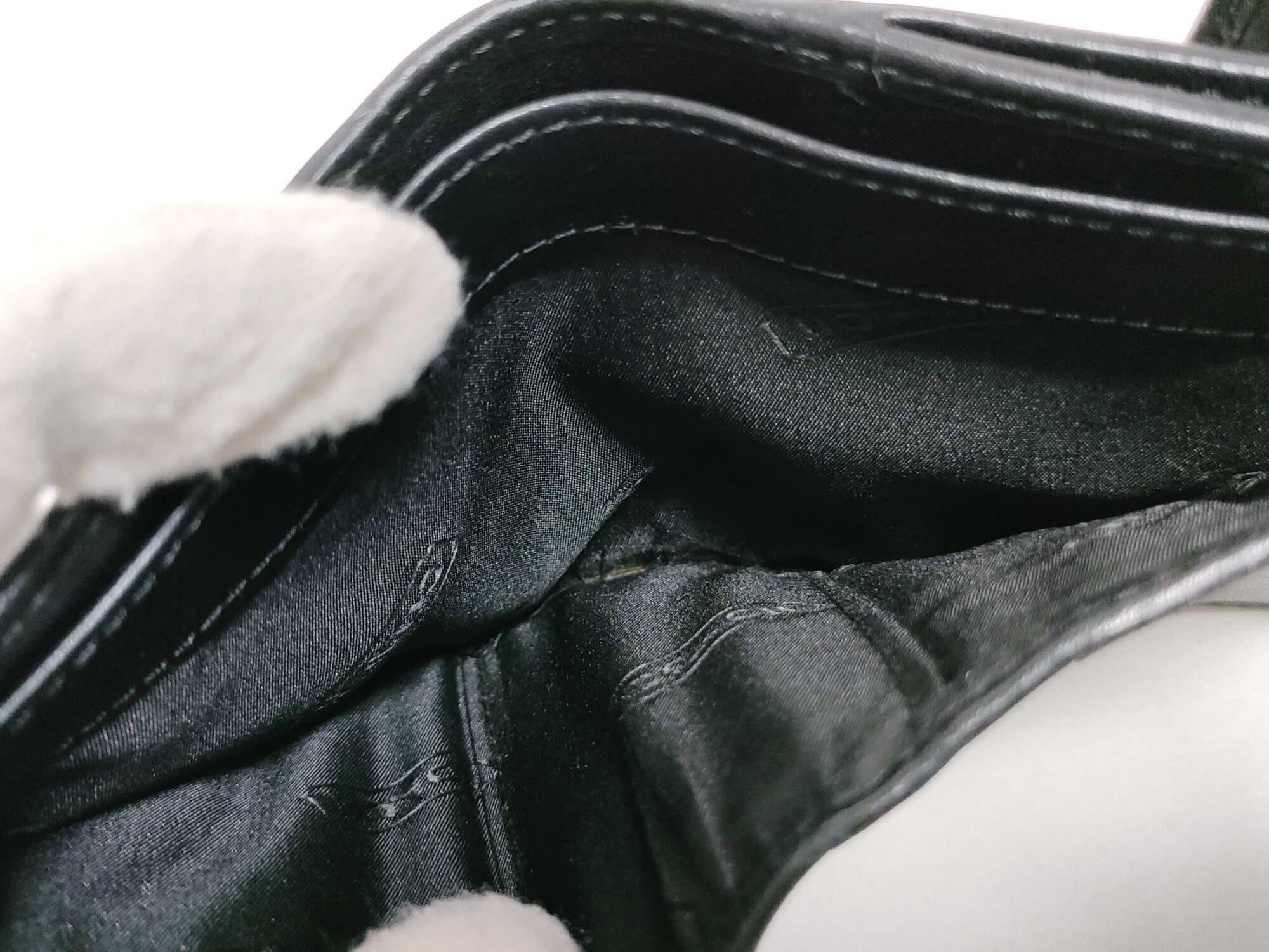 Interior view of full-length horizontal billfold section with black jacquard textile lining.