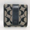 Front view of Coach Signature Stripe black jacquard and leather compact bifold wallet.