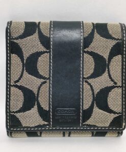 Front view of Coach Signature Stripe black jacquard and leather compact bifold wallet.