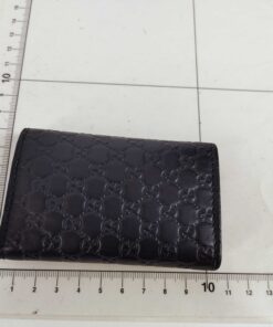 Gucci black leather key case on centimeter measuring grid