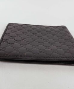 Opposite side profile of folded black Gucci Microguccissima leather bifold wallet