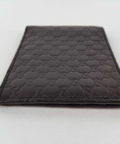 Bottom edge view of folded black leather Gucci Microguccissima bifold wallet