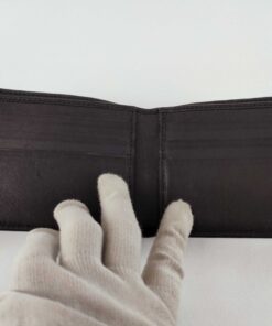 Full open interior of Gucci black leather bifold wallet showing card slots