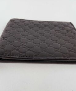 Top edge opening of folded black Gucci bifold wallet showing bill compartment