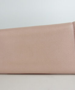 Back panel of the light pink Salvatore Ferragamo textured leather continental wallet.