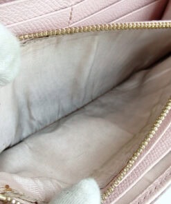 Open interior zippered coin compartment showing darkening and coin residue on the textile lining.