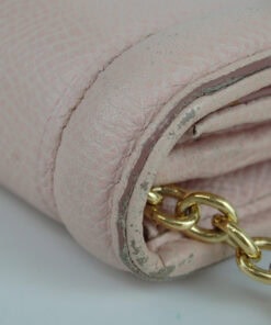 Close-up of the wallet edge and chain attachment showing rubbing along the trim.