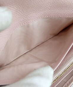 Open interior billfold compartment lined in clean pale pink textile fabric.