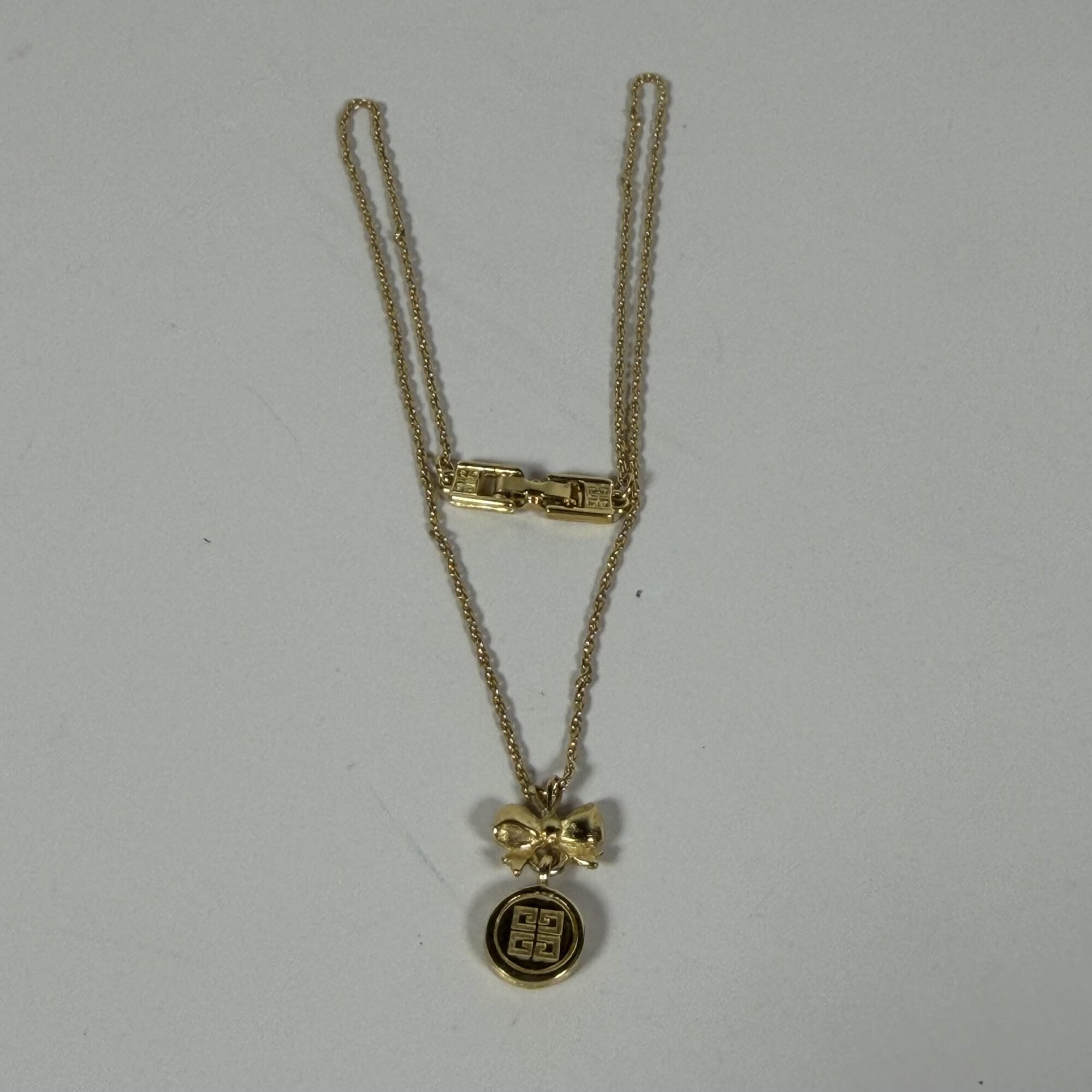 Vintage Givenchy Gold Tone Bow & 4G Logo Circle Pendant Necklace