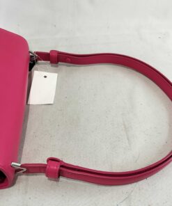 Top view of smooth pink leather shoulder strap and bag flap