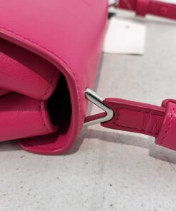 Side gusset showing silver-tone strap anchor hardware and smooth leather edge
