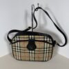 Burberrys Haymarket check canvas crossbody bag with black leather trim and shoulder strap.