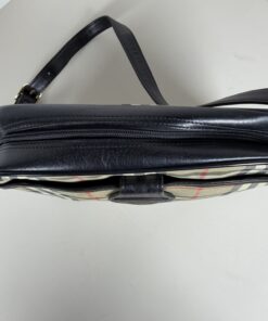 Top view of Burberrys crossbody bag showing black leather panel and zipper closure.