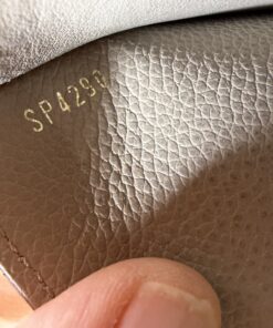 Close-up of date code stamp SP4290 on interior taupe leather.