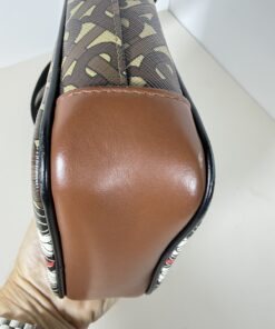 Close-up of brown leather base corner showing minor surface scuff