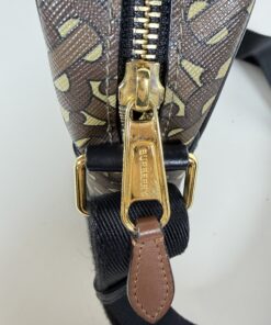 Gold-tone zipper pull engraved with Burberry logo and leather pull tab